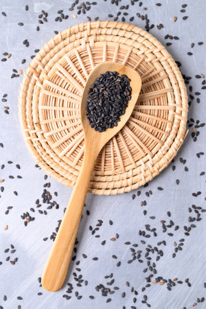 Black sesame seed in wooden spoon, Food ingredient, Top viewの写真素材