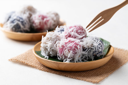 Thai coconut ball (Khanom Tom), Traditional Thai dessert made from boiled glutinous rice flour stuffed with sweet coconut and coated with shredded coconutの写真素材