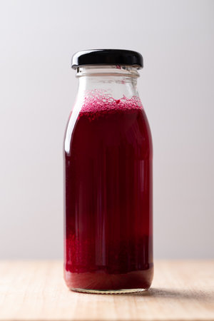 Fresh beetroot juice in bottle on wooden board, Healthy drinkの写真素材