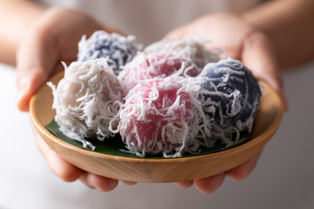 Thai coconut ball (Khanom Tom), Traditional Thai dessert made from boiled glutinous rice flour stuffed with sweet coconut and coated with shredded coconutの写真素材