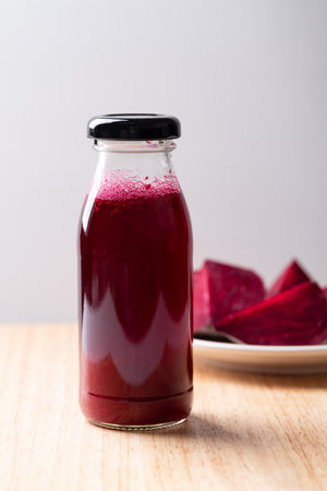 Fresh beetroot juice in bottle on wooden board, Healthy drinkの写真素材