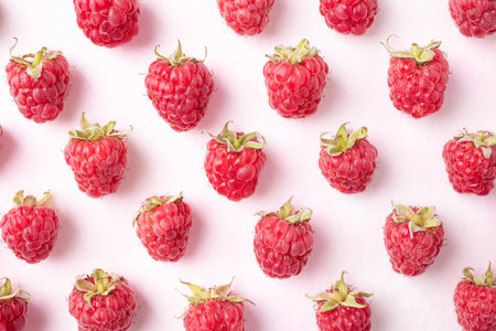 Flat lay of fresh ripe raspberry with leaf on pink background, Summer fruit, Top viewの写真素材