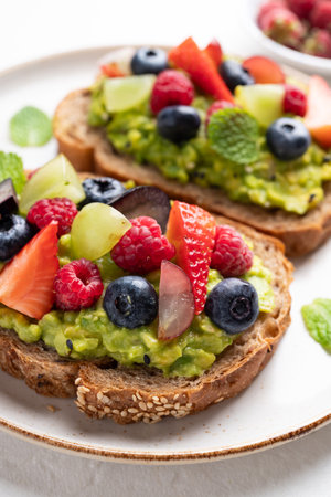 Avocado toast with strawberry, blueberry, raspberry and grape. Healthy eating