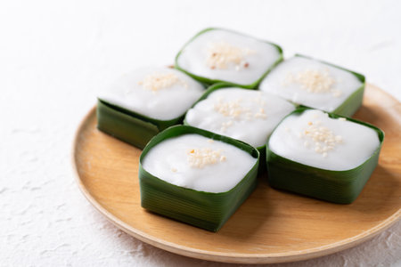 Traditional Thai dessert (Khanom Tako), Pudding with coconut cream topping in pandan leafの写真素材