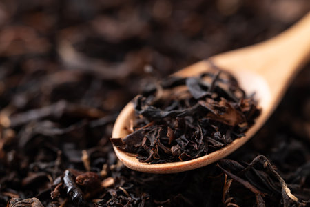 Dried black tea leaves in wooden spoon, Herbal tea