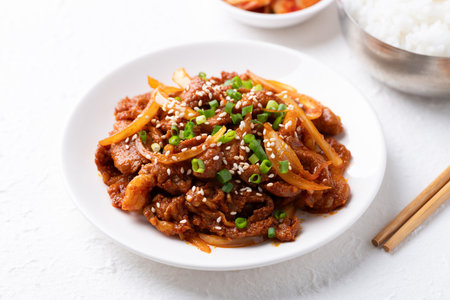 Korean stir fried spicy pork (Bulgogi) with cooked rice and kimchi on white backgroundの写真素材