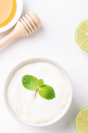 Yogurt, lime and honey on white backgroundの写真素材