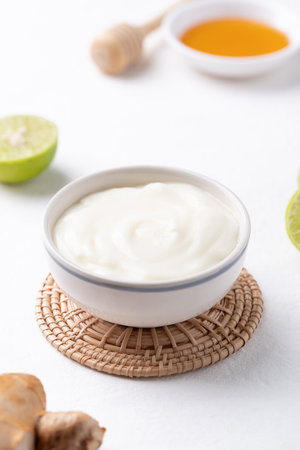 Yogurt, lime, honey and ginger on white backgroundの写真素材