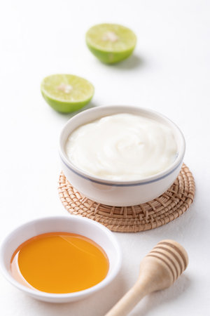 Yogurt, lime and honey on white backgroundの写真素材