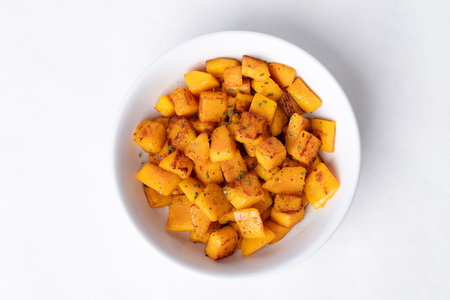 Top view of roasted butternut squash pumpkin in a bowl on white background, Autumn homemade foodの写真素材