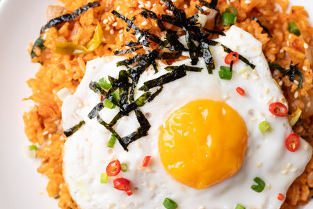 Kimchi fried rice with fried egg, pork, sesame seed, chili, spring onion and seaweed, Korean food, Close up, Top viewの写真素材