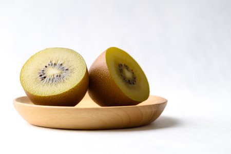 Fresh kiwi fruit with wooden plate on white background, Healthy fruitの写真素材