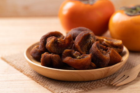 Dried persimmon on wooden plate ready to eating, Sweet and chewyの写真素材