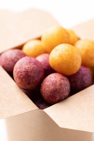 Deep fried sweet potato balls in paper box, Thai street food snackの写真素材