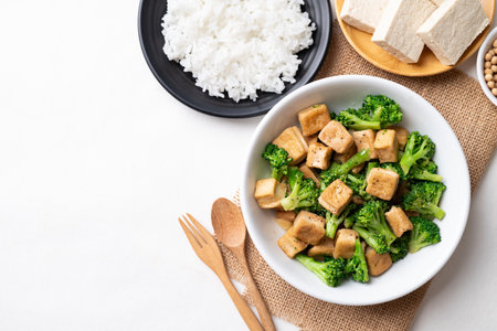 Stir fried tofu and broccoli with soy sauce eating with cooked rice, Asian vegan food, Top viewの写真素材