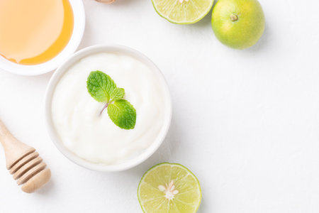 Yogurt, lime and honey on white backgroundの写真素材