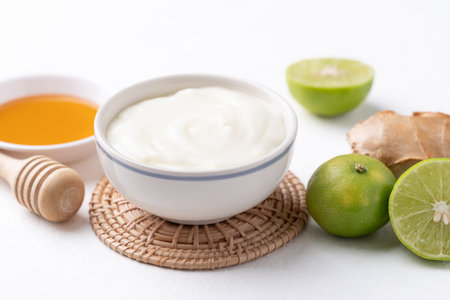 Yogurt, lime, honey and ginger on white backgroundの写真素材