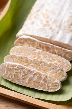 Tempeh made from fermented soybeans wrapped by banana leaf, Traditional Indonesian food, Healthy vegan and plant based ingredientsの写真素材