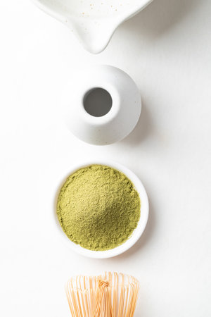 Top view of matcha green tea powder with bamboo whisk and Chawan bowl on white backgroundの写真素材