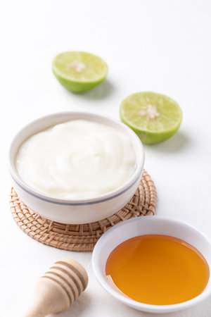 Yogurt, lime and honey on white backgroundの写真素材