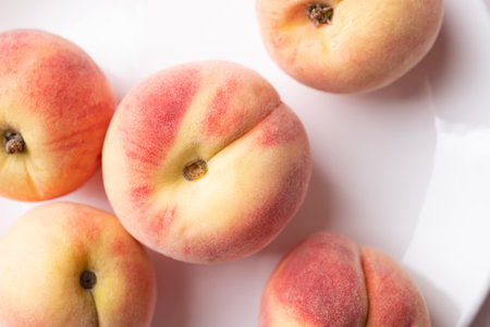 Pink peaches on white plate, Summer fruit, Top viewの写真素材