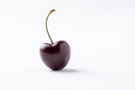 Fresh ripe cherry fruit on clean white background, minimal style, Healthy eating and seasonalの写真素材