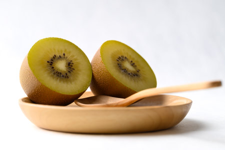 Fresh kiwi fruit on wooden plate with spoon, Healthy eatingの写真素材