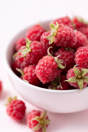 Fresh ripe raspberry with leaf in bowl, Summer fruit