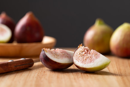 Fresh sliced fig on cutting wooden board, Autumn fruit