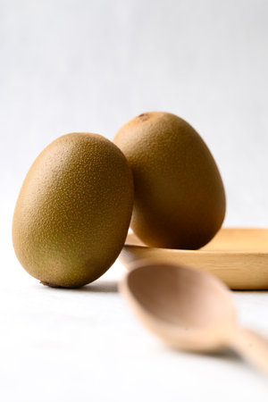 Fresh kiwi fruit with wooden spoon on white background, Healthy eatingの写真素材