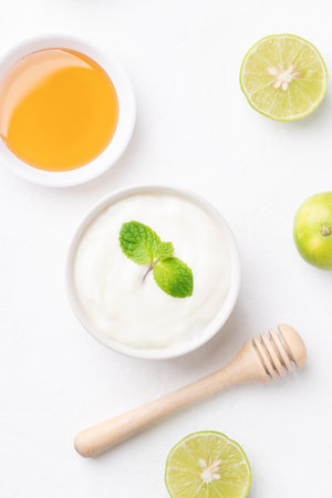 Yogurt, lime and honey on white backgroundの写真素材