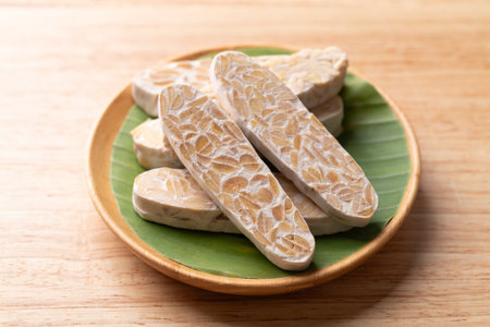 Sliced tempeh made from fermented soybeans, Traditional Indonesian food, Healthy vegan and plant...