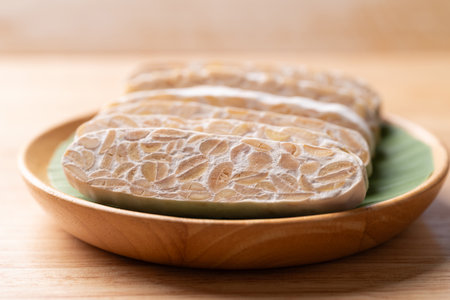 Sliced tempeh made from fermented soybeans, Traditional Indonesian food, Healthy vegan and plant...