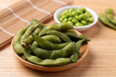 Boiled Edamame beans (Japanese soybeans) on wooden backgroundの写真素材