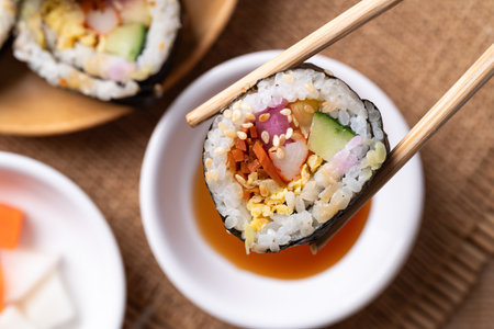 Kimbap or Gimbap, Korean food made from cooked rice with vegetables, egg and wrapped with dried seaweed eating with dipping sauceの写真素材