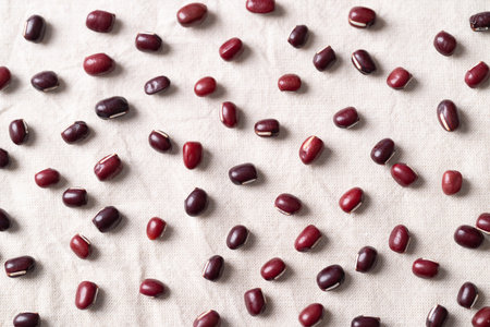 Azuki beans, Adzuki bean or red mung beans on white fabric background, Food ingredients in many Chinese dishes and filling in Japanese sweetの写真素材