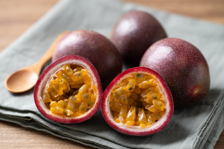 Fresh passion fruit and wooden spoon on fabric, Tropical fruit