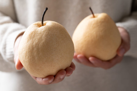 Fresh Asian pears holding by woman handの写真素材