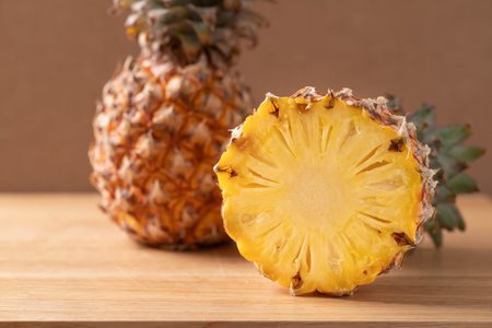 Half of fresh ripe pineapple on a brown wooden background, Tropical summer fruit