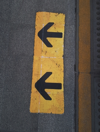 Black arrow sign on the floor