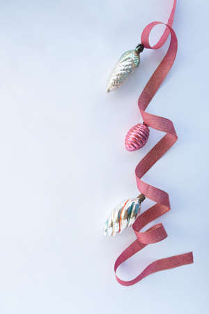 Red ribbon decorated with Christmas decorations on a white background. space for text, advertising photo.の写真素材