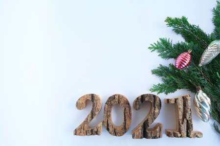 On a white background, the numbers 2021 and a Christmas tree branch. space for text, advertising photo.の写真素材