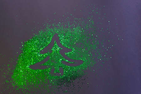 On a black festive background scattered green sequins and painted herringbones. Festive background...