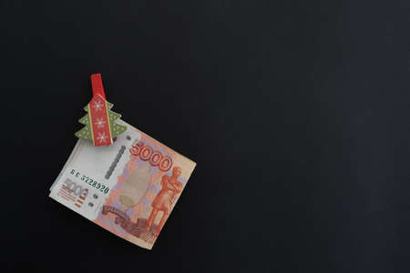 On a black background money with a clothespin, Russian five-thousandth rubles. Economy concept,...