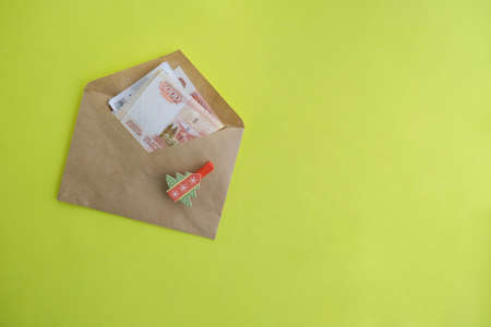 On a yellow background, an envelope with money, Russian five thousandth rubles. Economy concept, money distribution. Gift for the new year.の写真素材