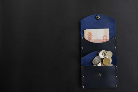 On a black background, a blue wallet with money. Banknotes of five thousand rubles.の写真素材