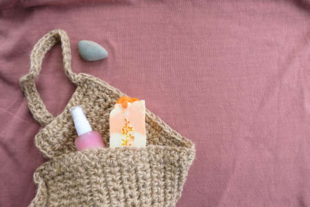 Flat composition with natural soap and washcloth on pinkの写真素材