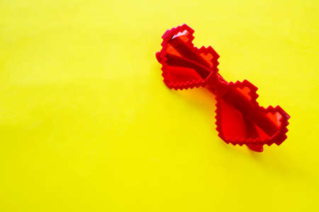 Valentines day concept. Heart-shaped glasses on a yellow background. Cute love sale banner or greeting card. High quality photoの写真素材