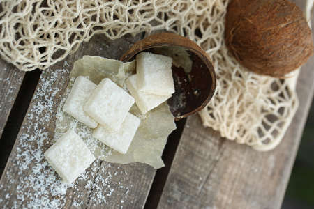 Coconut marshmallow in coconut scarlop. Photo on a wooden background. Natural product. High quality photoの写真素材