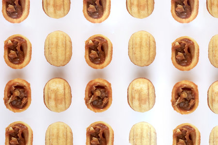 Creative mockup made of cookies in the shape of a nut and walnut. Flat lay. Food concept. Cookies on a white background. High quality photoの写真素材